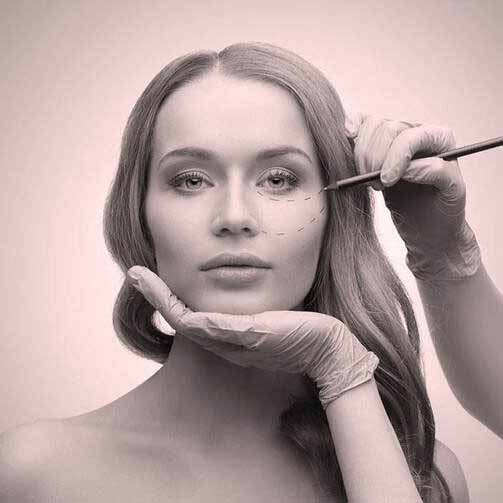 Alt: Clinician marking the under-eye and cheek area before a non-surgical thread lift treatment