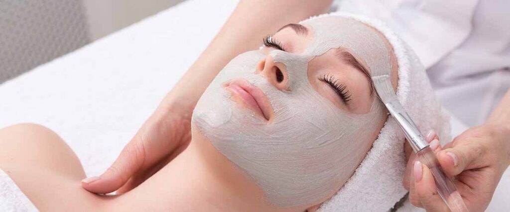 Patient receiving a professional facial resurfacing treatment mask as part of skin exfoliation and renewal care